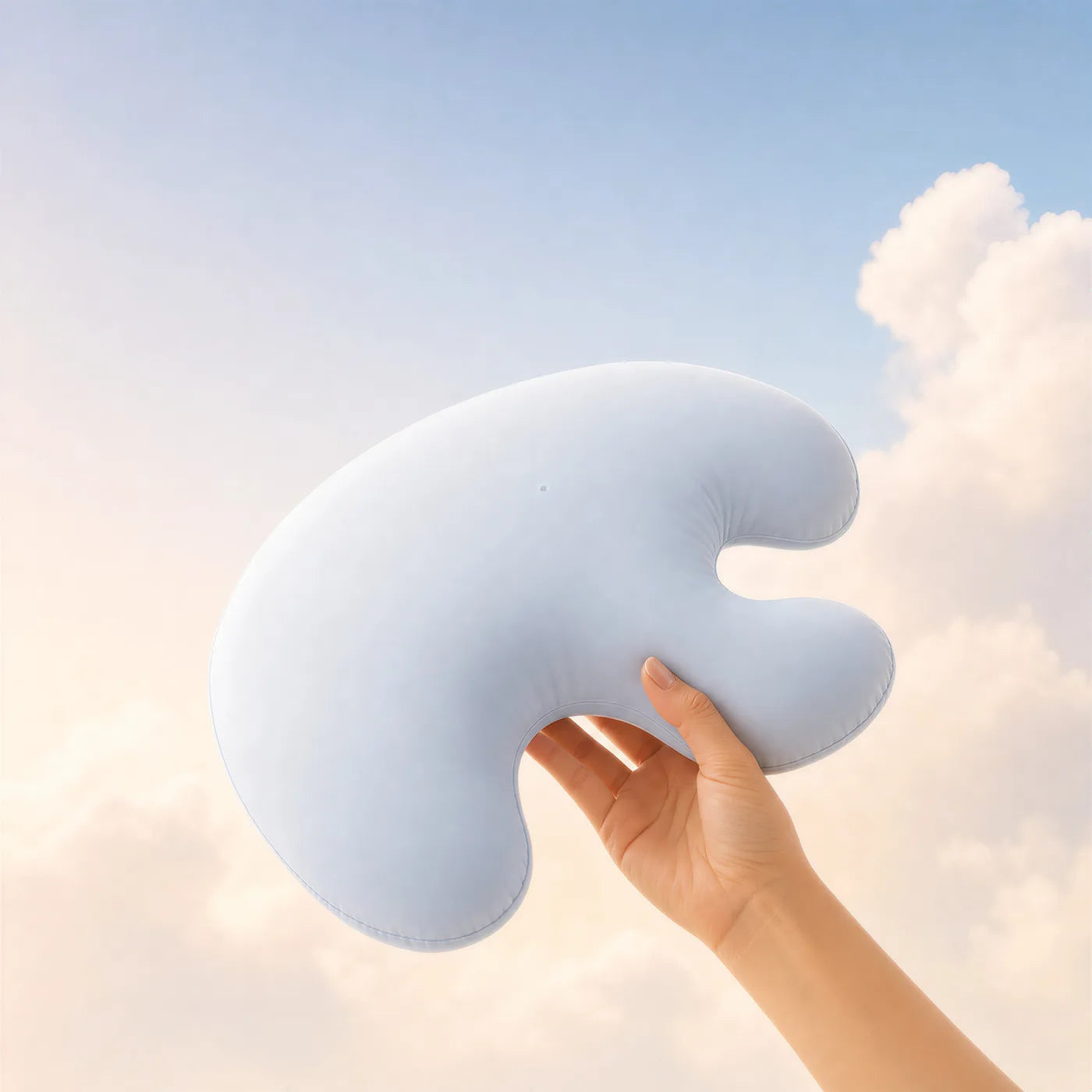 The Booney pillow held in one hand to show its size